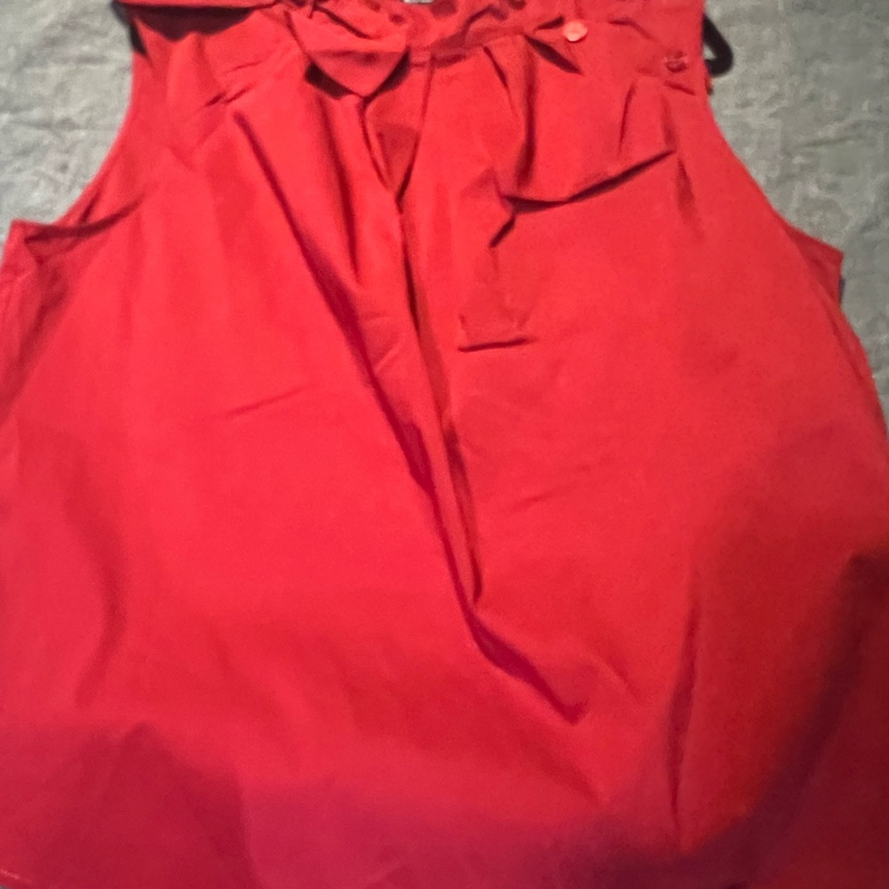 Red cotton blouse with bow on side neck.